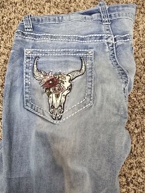 Light Blue Bootcut Jeans with Embroidered Skull Pocket